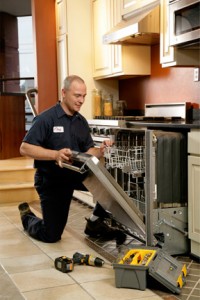 Man installing dishwasher in kitchen