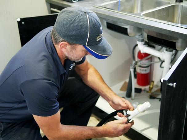 mn-plumbing-home-services-home-plumber mn plumber working on a sink