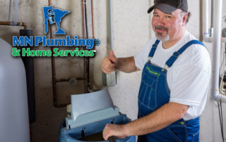 Plumber installing water softener