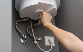 Woman adjusting the temperature on MN Water Heater unit