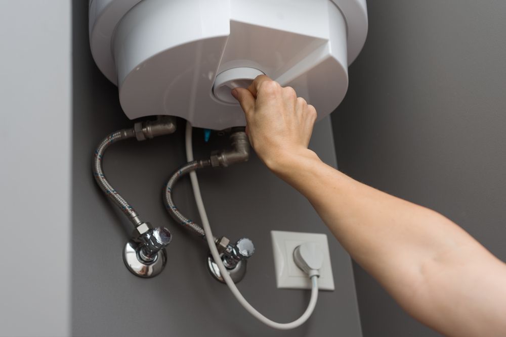Woman adjusting the temperature on MN Water Heater unit